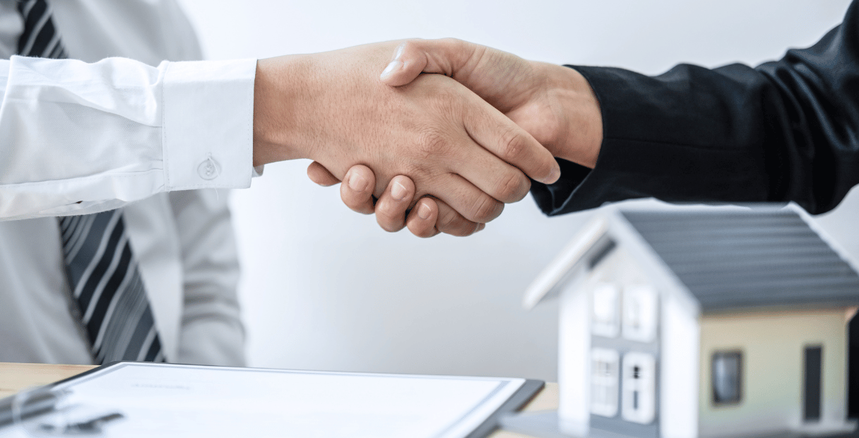 Two people shaking hands after finding out that foreigners can buy us real estate