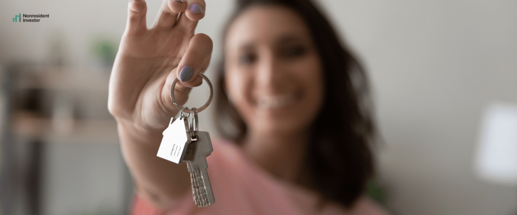 a tenant holding keys and smiling
