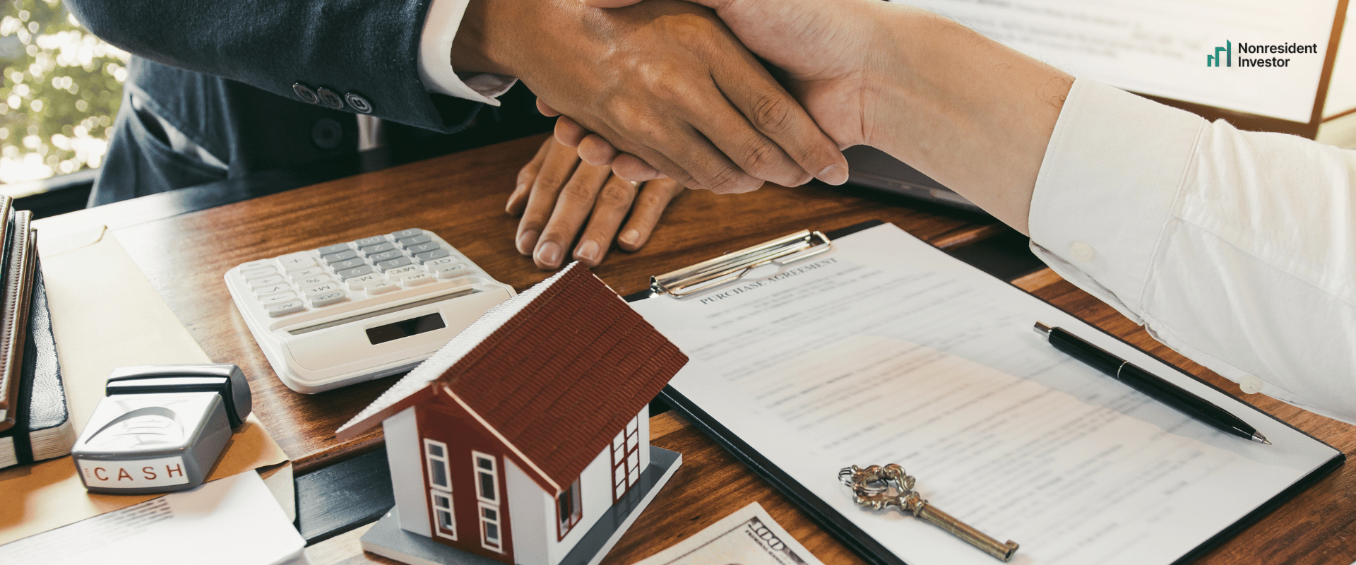 a registered agent and foreigner investor shaking hands after opening a us llc for a nonresident investor